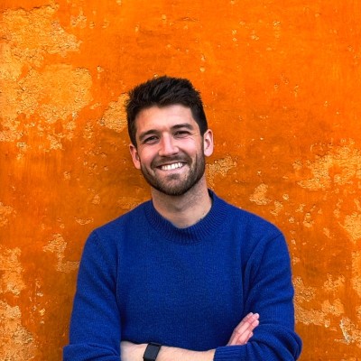 Lucas Dubois, smiling in front of an orange wall